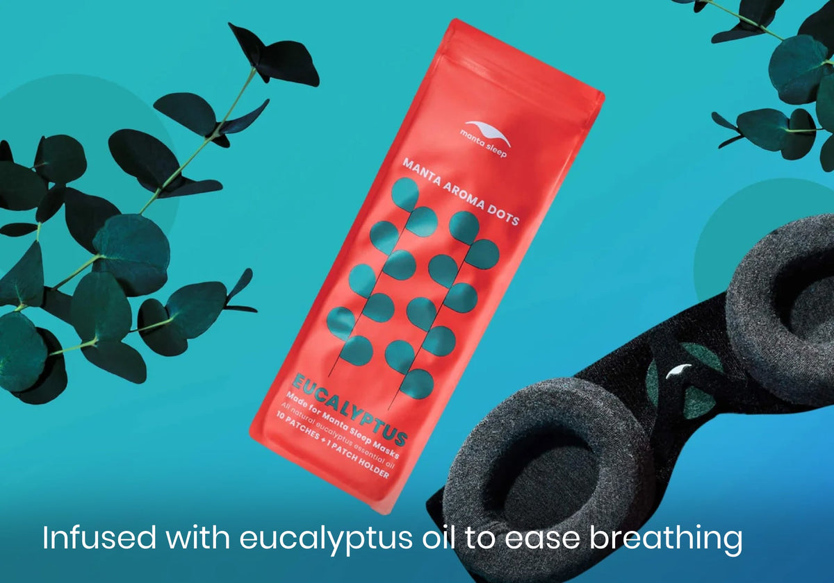 Manta Aroma Dots packet next to black sleep mask and eucalyptus branches with text "Infused with eucalyptus oil to ease breathing".